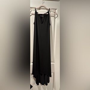 Black halter top dress with cutout on neckline. longer in the back. Size S